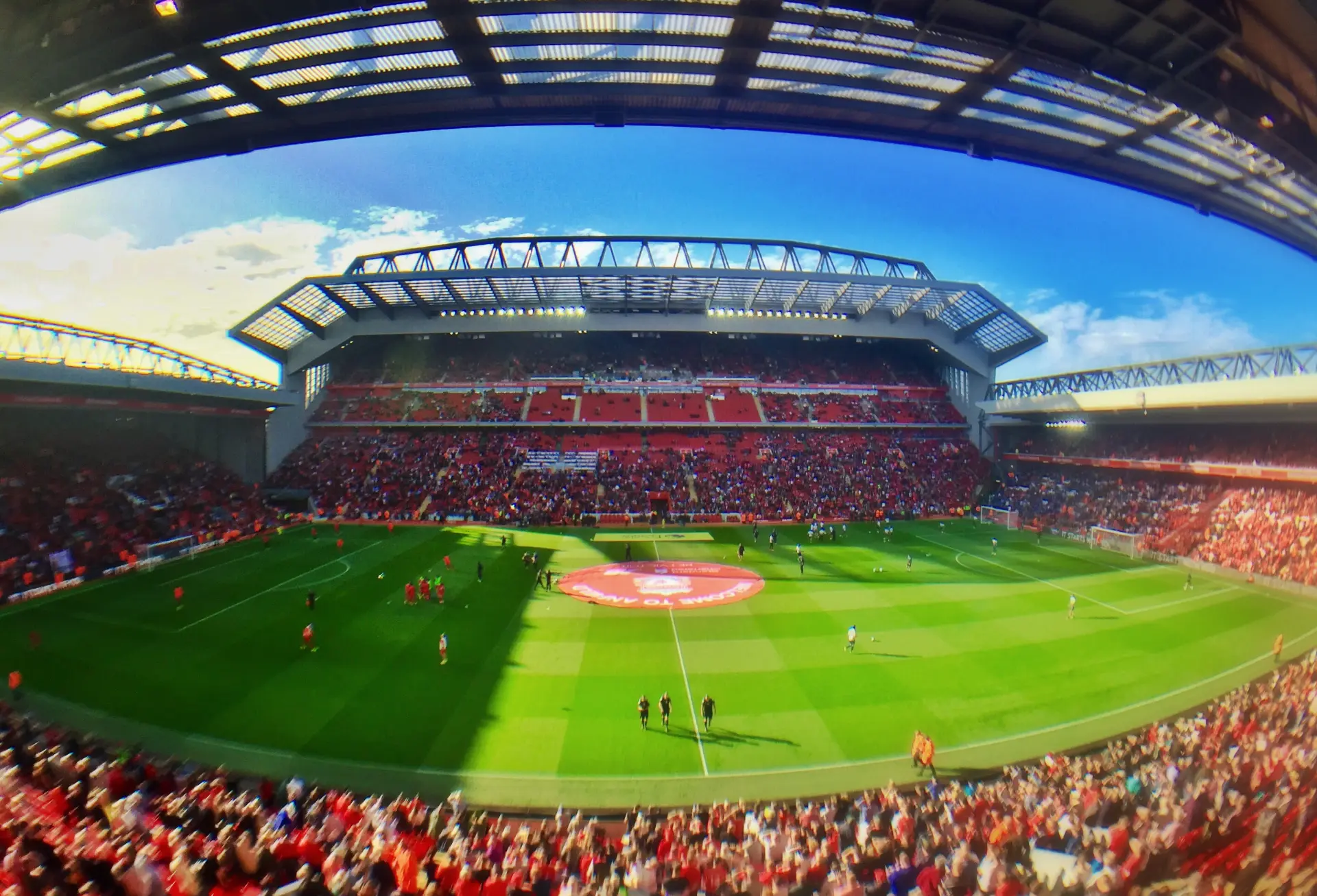 A packed Anfield stadium under floodlights on matchday